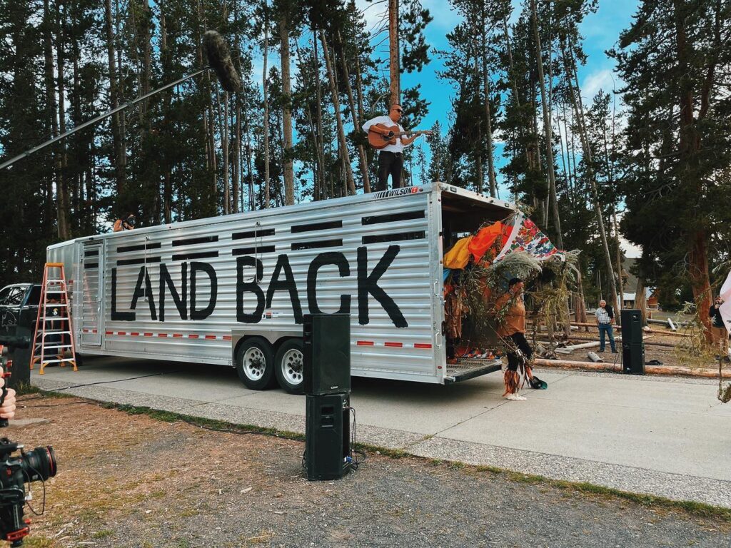 Christian Wallowing Bull sings as the buffalo dancers exit the trailer for the Yellowstone Revealed "REMATRIATE" performance. h/t Fiadh Vincent photo