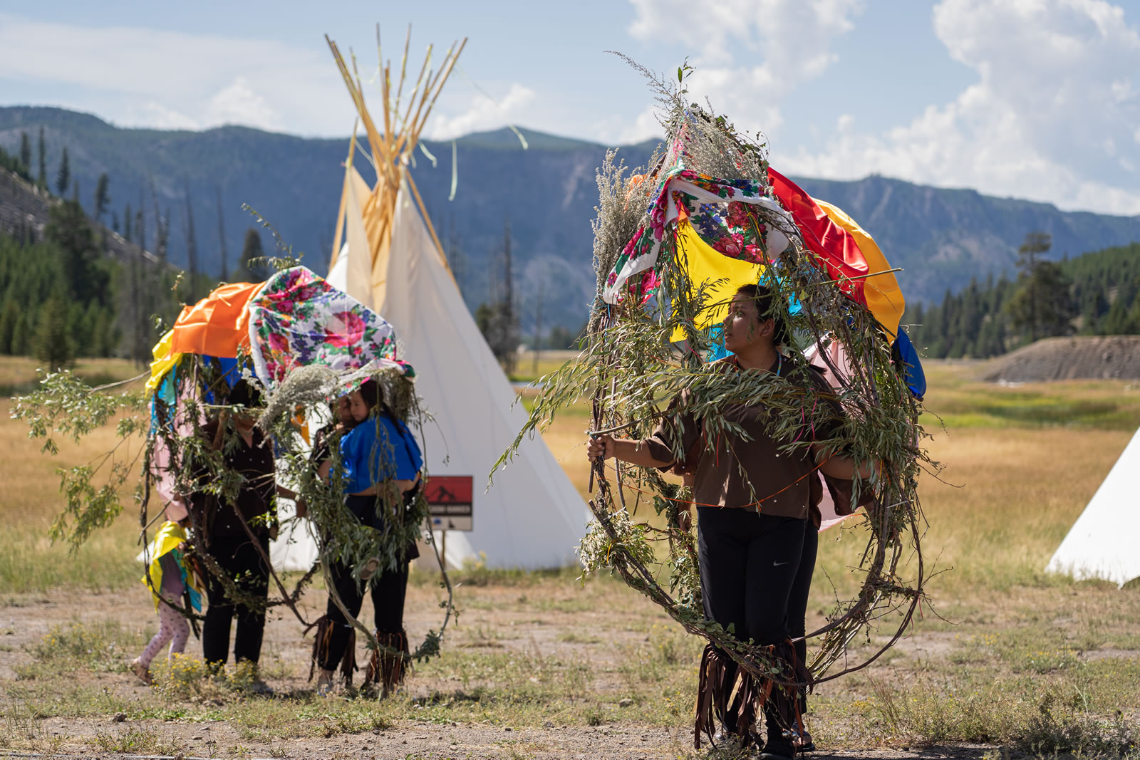 Dancers and their buffalo sculptures. The buffalo sculptures were built using willow branches, red willow (water birch) branches, sage, twine, and silk handkerchiefs. (Photo GYC/Emmy Reed)